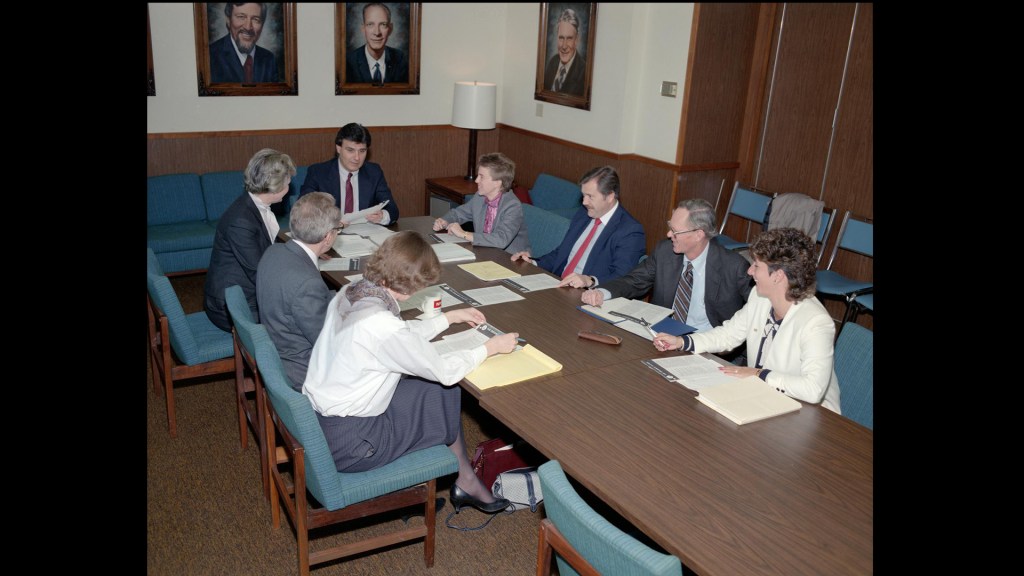 Group sitting at conference table.