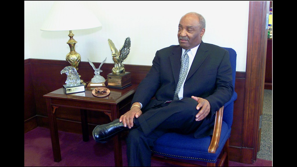 Man sitting in chair in office.