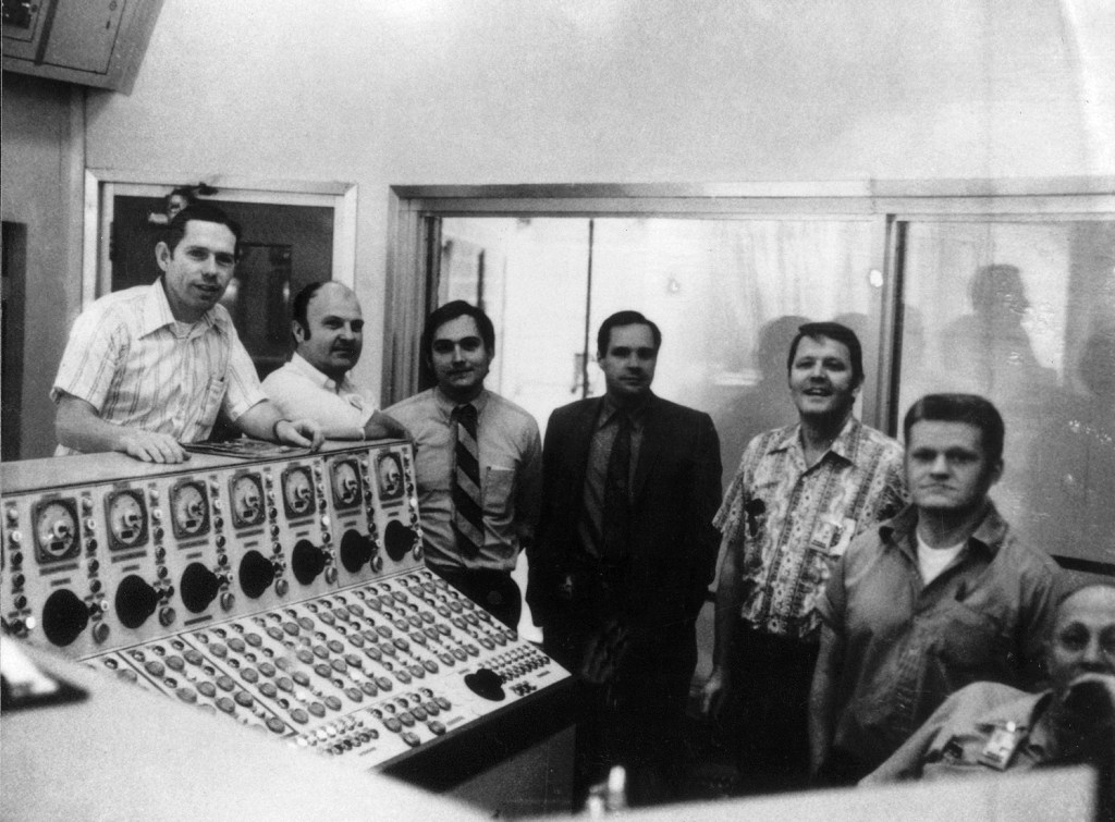 Men in control room.