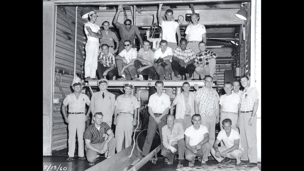 Group of men posing for photograph at J-2
