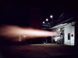 Rocket engine firing horizontally out of J-1 at night