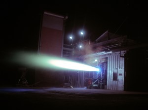 Rocket engine firing horizontally out of J-1 at night