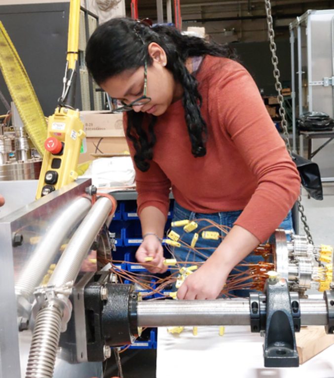 Glenn engineer configures thermocouples on a heat pipe setup for space thermal testing at NASA Glenn.