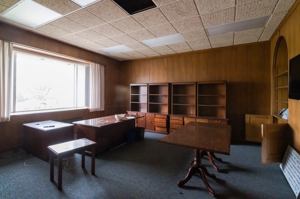 Wood-paneled office.
