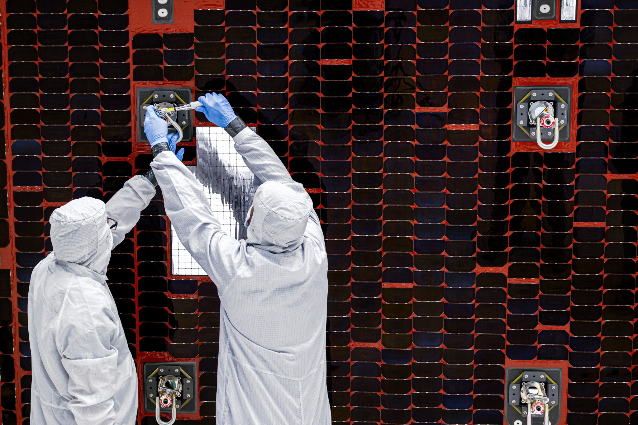 A close-up of technicians working on a Roman solar panel