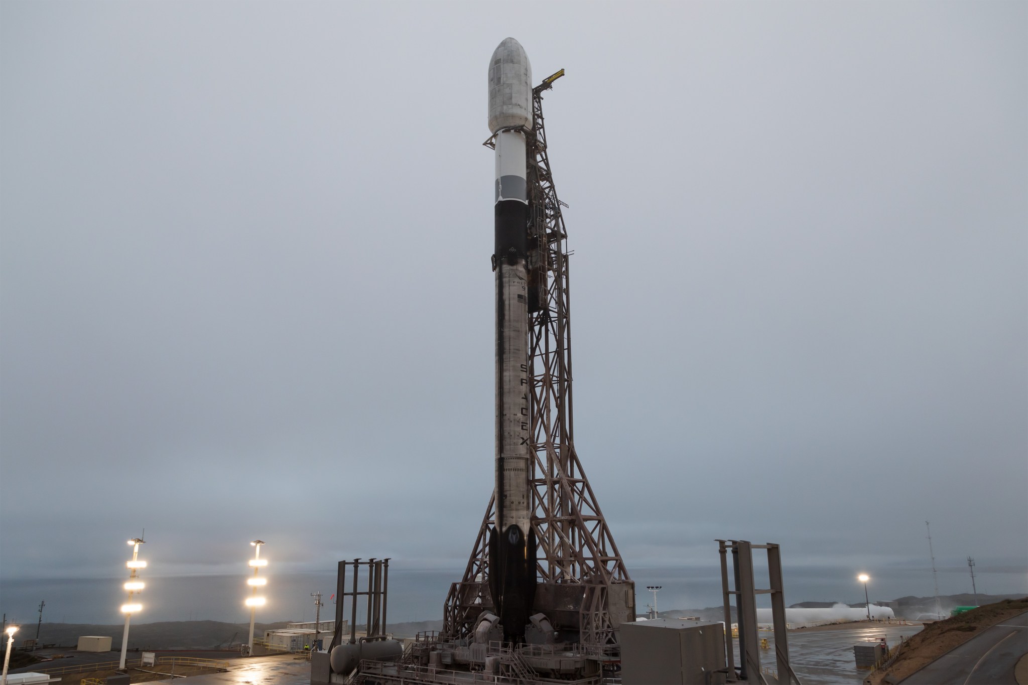 Image shows SpaceX rocket at launch pad carrying NASA payloads on an overcasts day in California