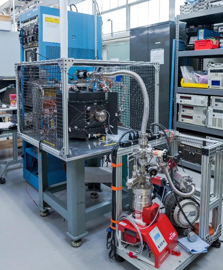 Laboratory setup of an americium-241 Stirling generator with a test enclosure, a vacuum system, and power instrumentation.