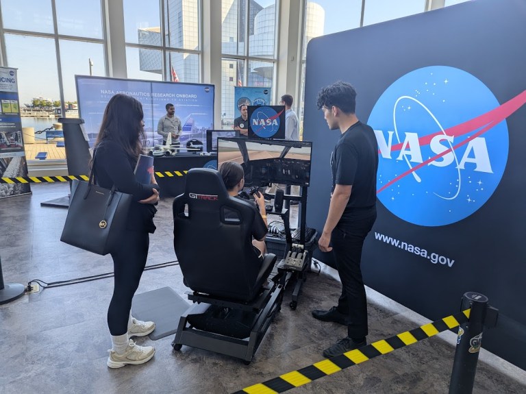 GVIS employee showcasing a hybrid electric flight simulator.