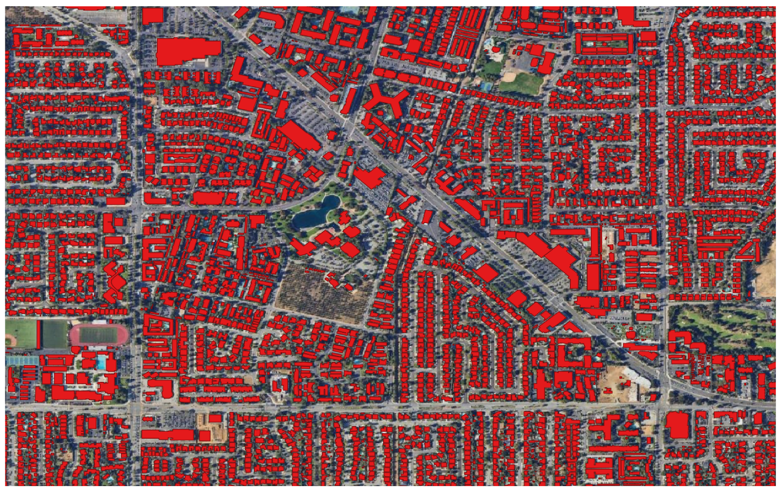 A satellite image of an urban area, with each building covered in red.