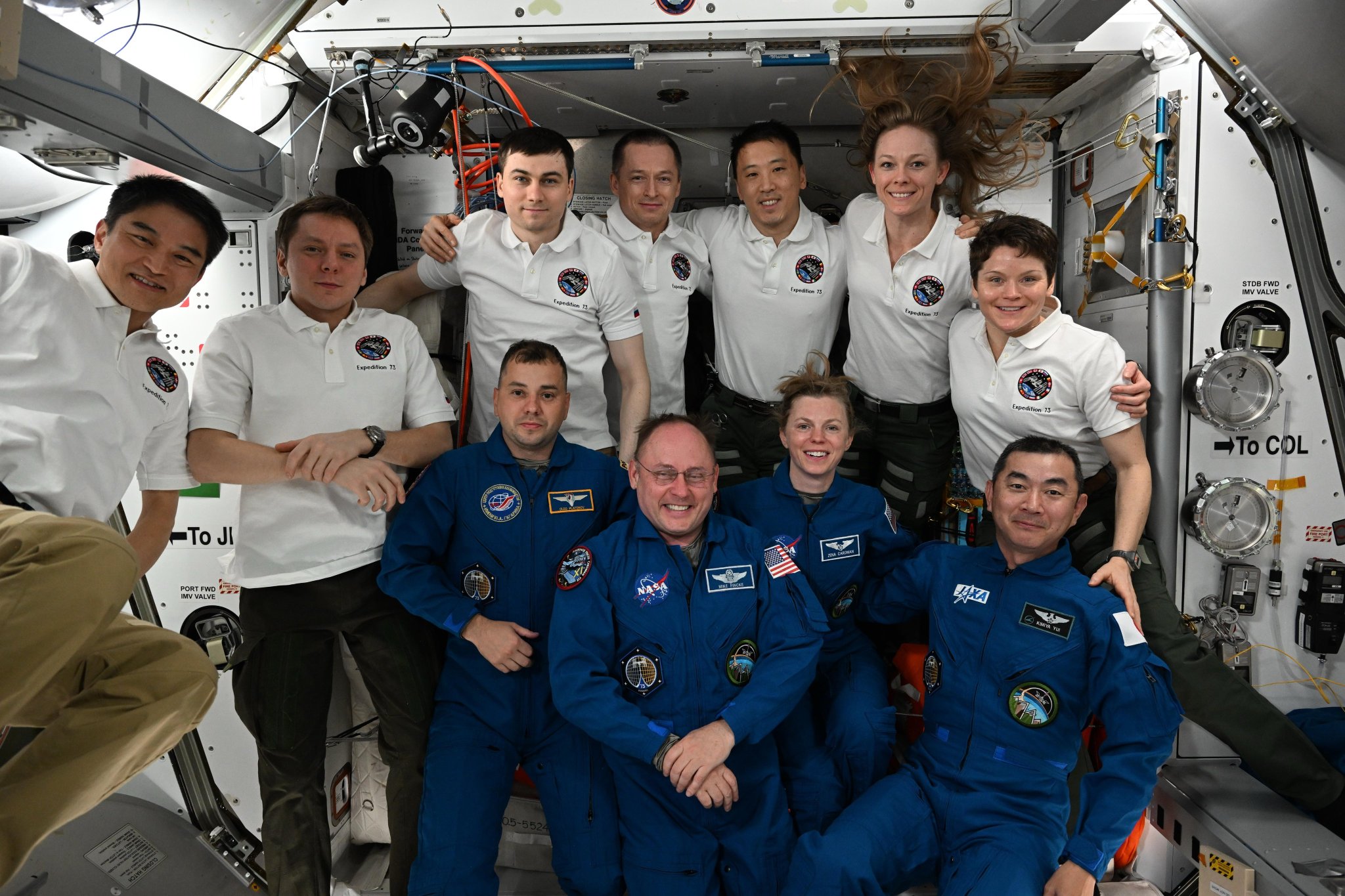 Expedition 73 welcomes NASA's SpaceX Crew-11 mission aboard the International Space Station. In the front from left are, Crew-11 members Oleg Platonov, Mike Fincke, Zena Cardman, and Kimiya Yui. In the back are, Expedition 73 members Takuya Onishi, Kirill Peskov, Alexey Zubritsky, Sergey Ryzhikov, Jonny Kim, Nichole Ayers, and Anne McClain.