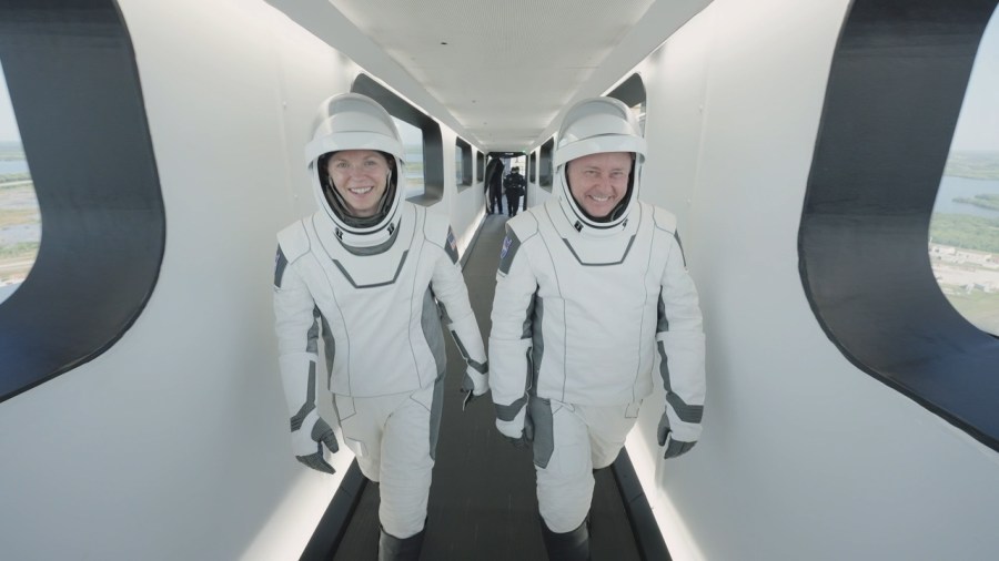 NASA astronauts Zena Cardman and Mike Fincke walk down the crew access arm of Launch Complex 39A at the agency's Kennedy Space Center in Florida, ahead of NASA's SpaceX Crew-11 launch on Friday, Aug. 1, 2025.