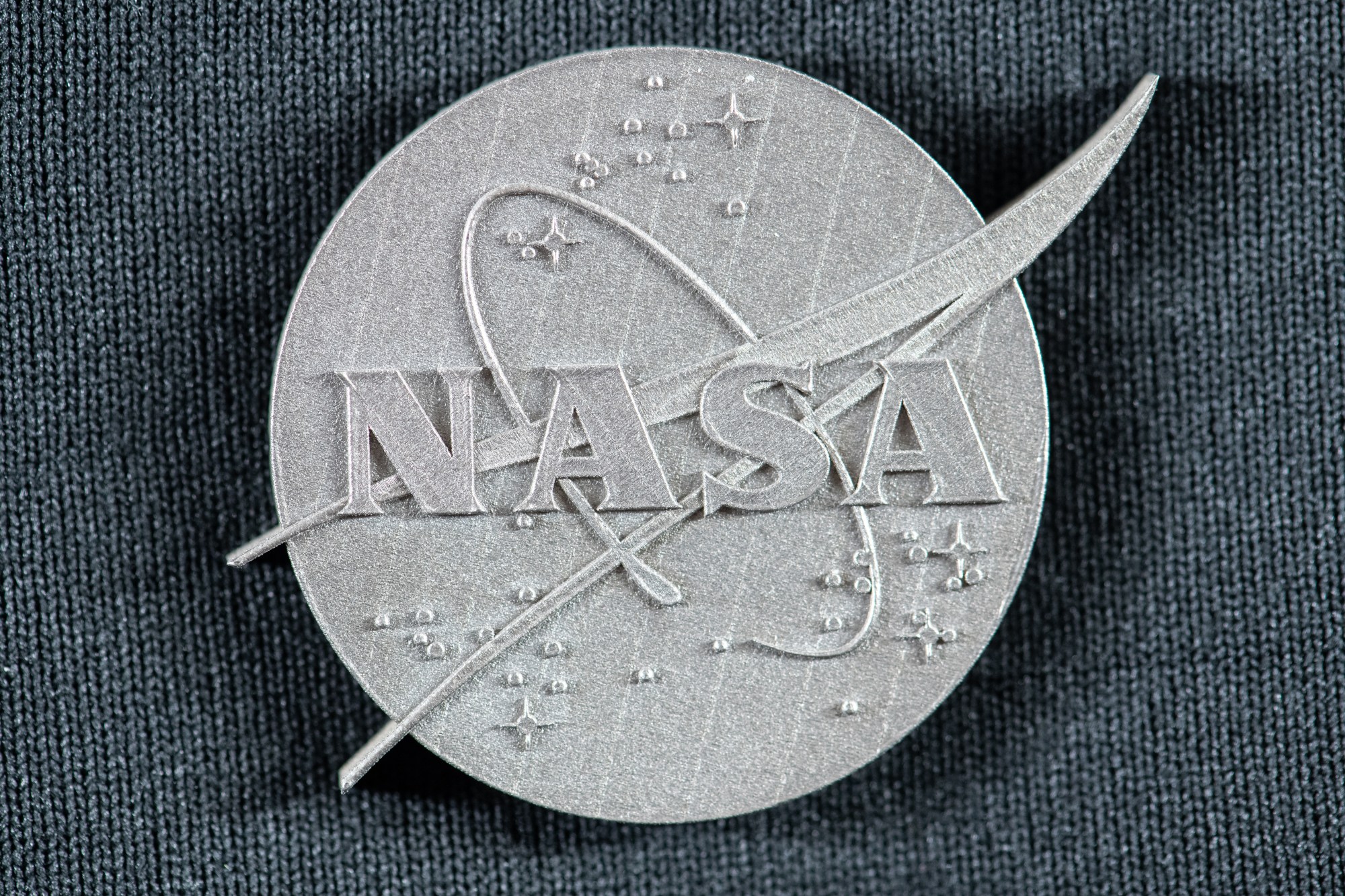 Alt Text: NASA’s GRX-810 3D-Printable Alloy in the Shape of the NASA Insignia.