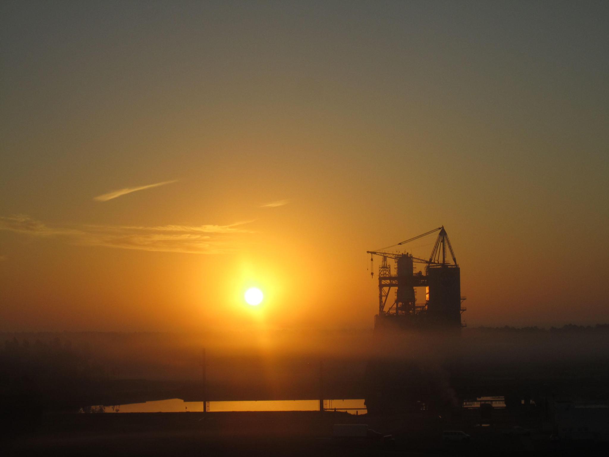 the sun setting behind test stand