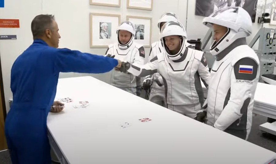 Astronauts playing cards.