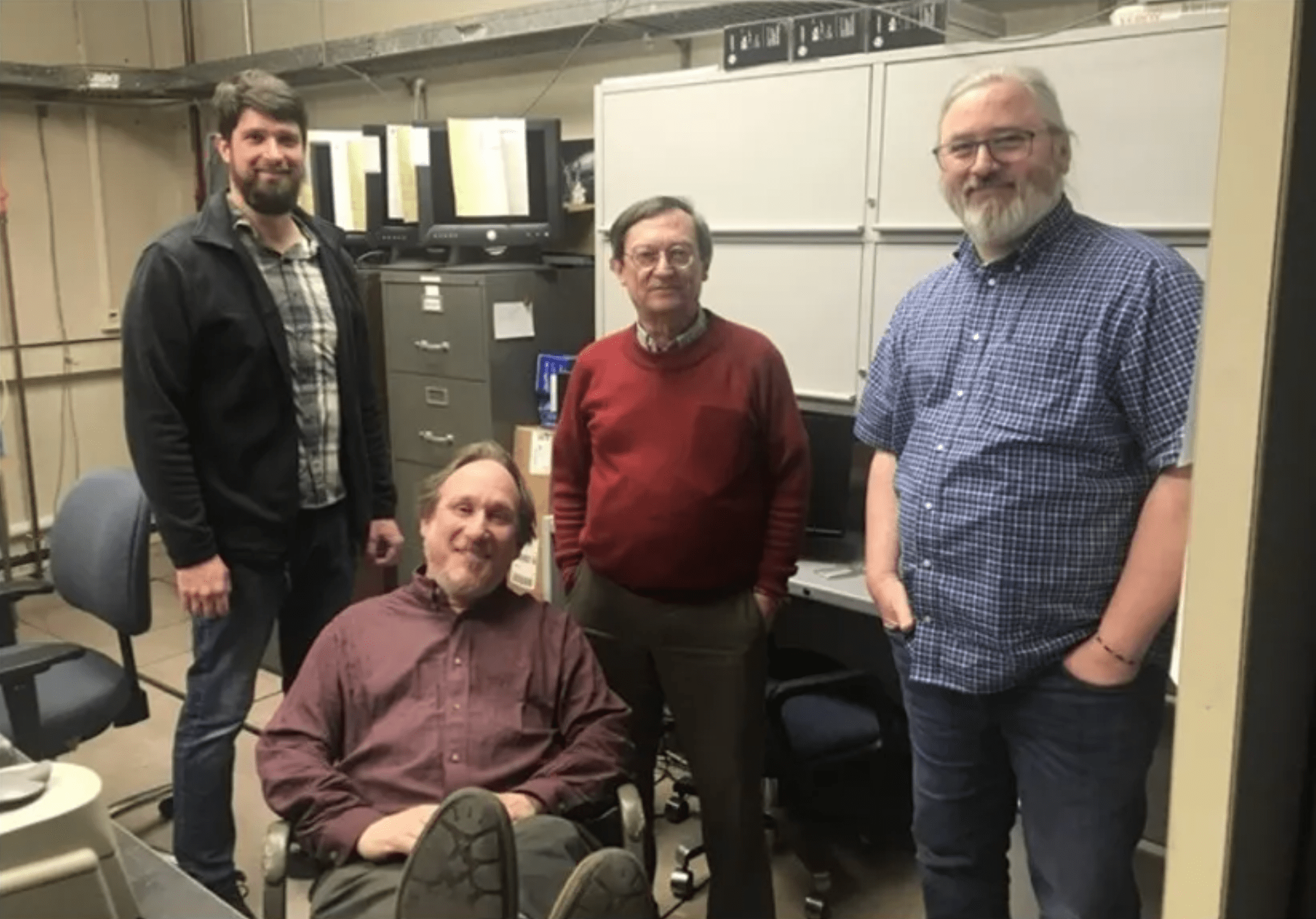 Image of the Cosmic Ice Laboratory group. Pictured right to left is Chris Materese, Reggie Hudson, Perry Gerakines with Max Bernstein.