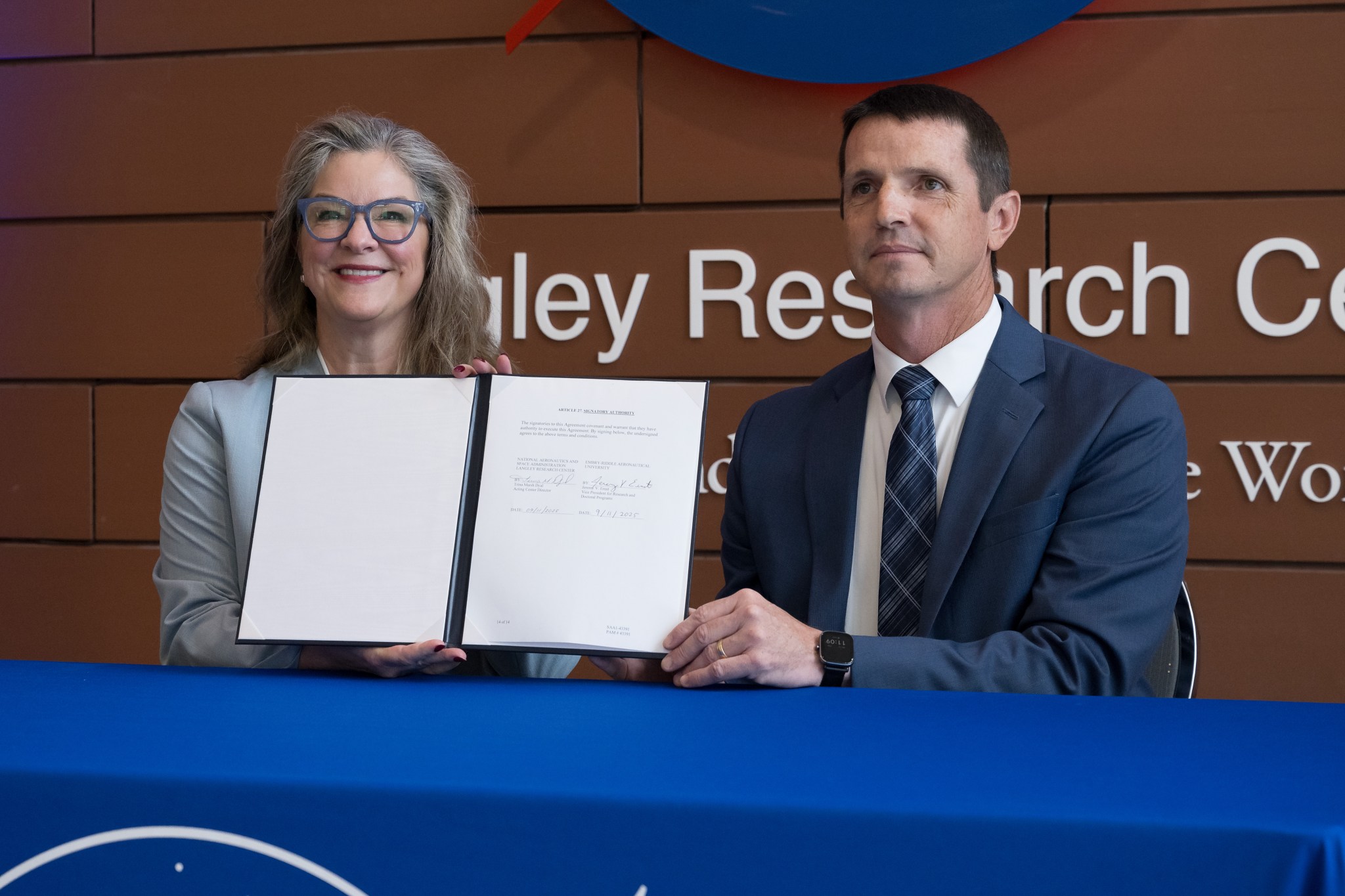 NASA’s Langley Research Center Acting Director Dr. Trina Marsh Dyal, left, and Dr. Jeremy Ernst, vice president for Research and Doctoral Programs at Embry-Riddle Aeronautical University, complete the signing of a Space Act Agreement during a ceremony held at NASA Langley in Hampton, Virginia on Thursday, Sept. 11, 2025