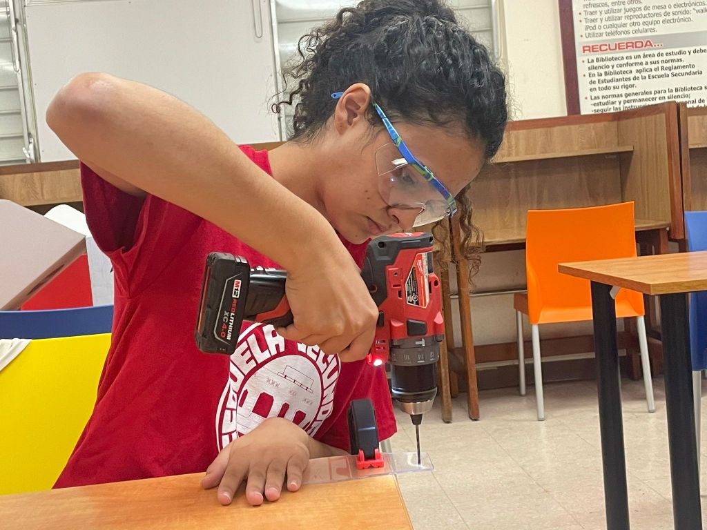 A student uses a drill