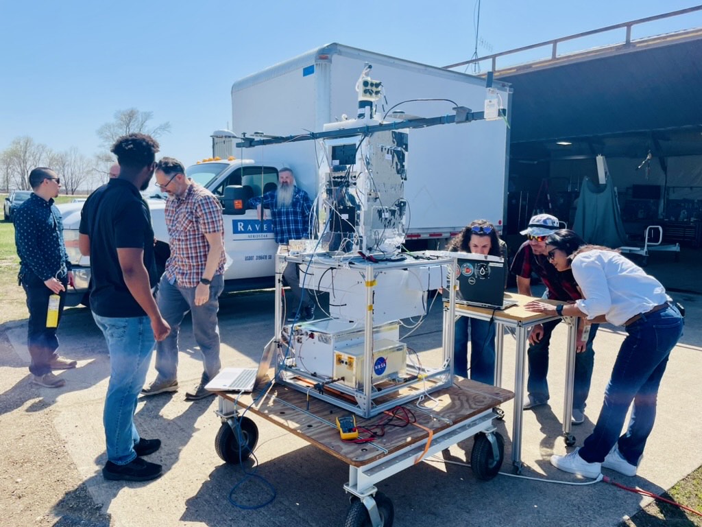 Image of the Flight Instrument Groups Team gathered for the preflight Functional testing of payload at Hurley Hangar, Aerostar, Sioux Falls, South Dakota.