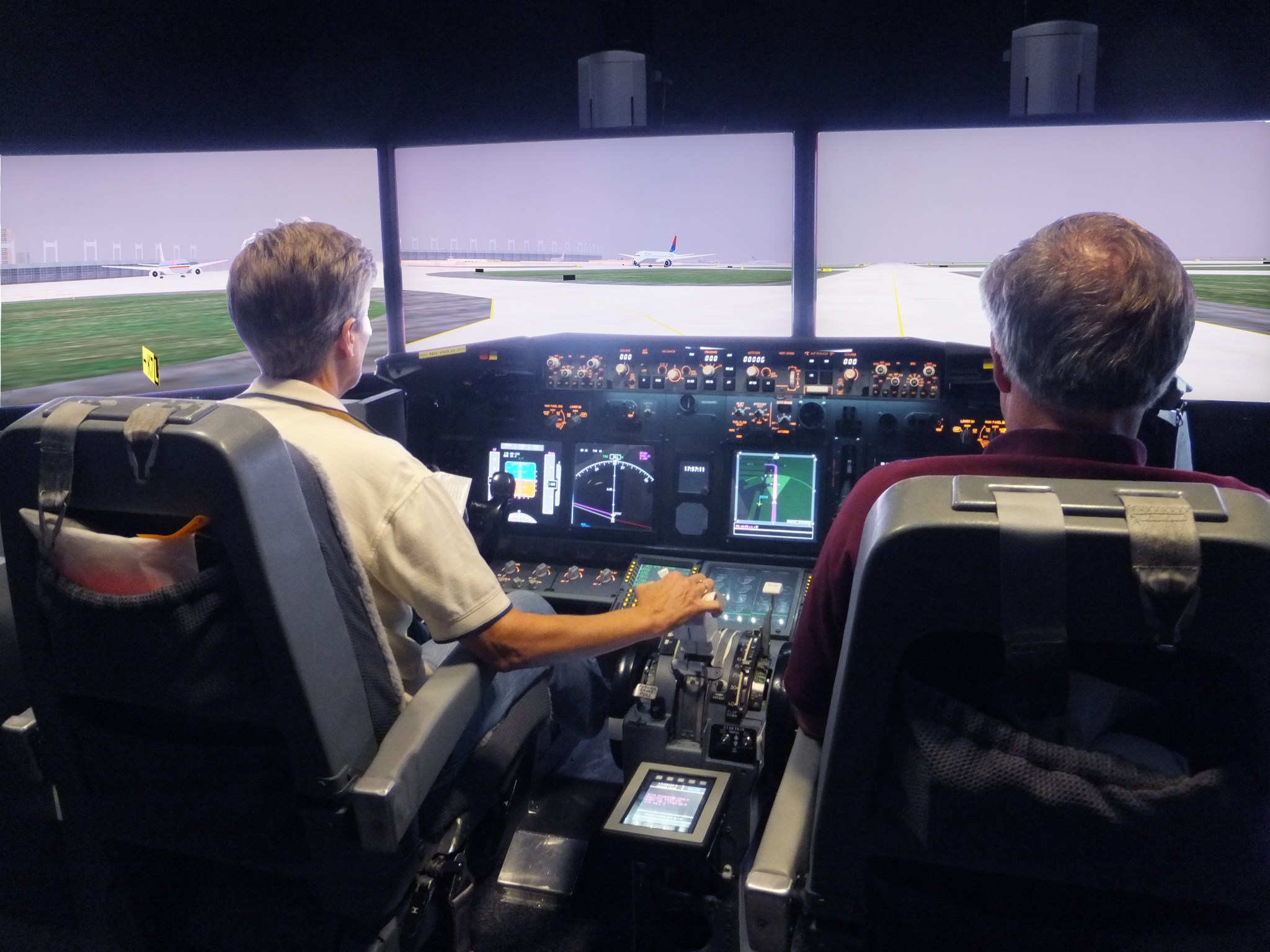 Research subjects testing out new advanced avionics display technology in the Human-Centered Systems Laboratory (HCSL) at NASA Ames Research Center.