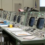 View of consoles in the Apollo Mission Control Center (MCC) at the completion of restoration efforts. Notebooks, coffee cups and ashtrays are seen as they were in 1969.