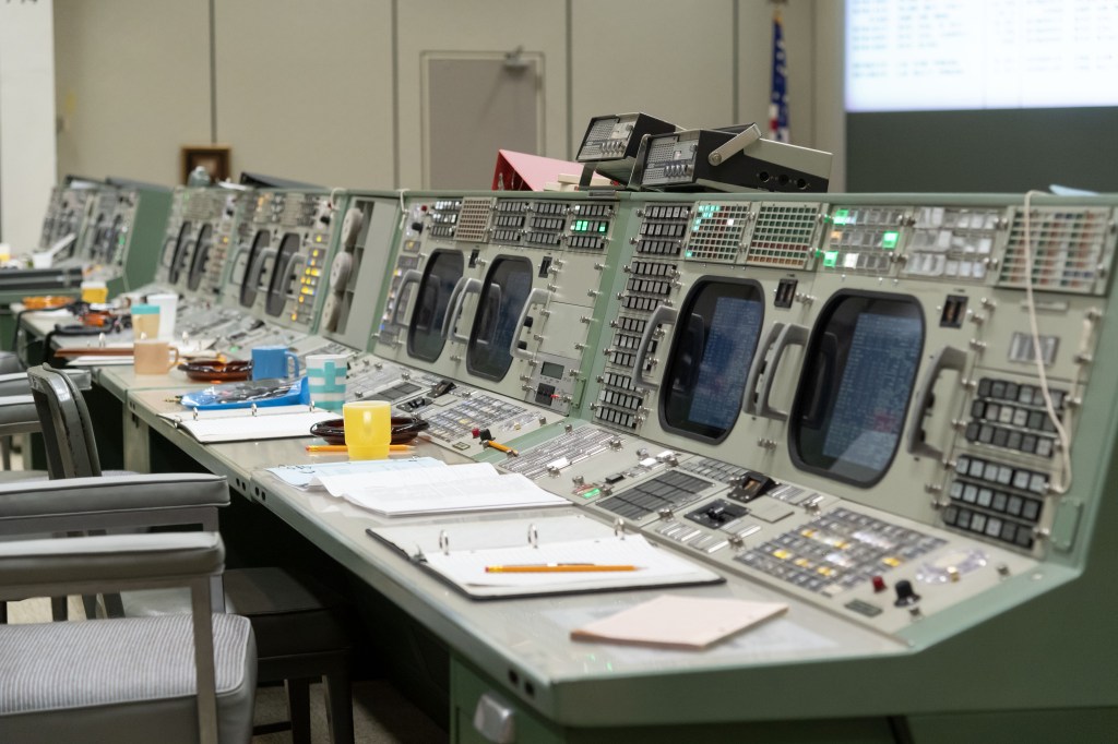 View of consoles in the Apollo Mission Control Center (MCC) at the completion of restoration efforts. Notebooks, coffee cups and ashtrays are seen as they were in 1969.