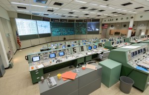 Consoles with documents and personal items and views of the front displays in restored Apollo MOCR in its final configuration.