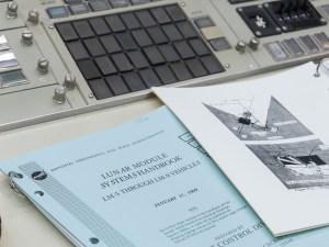 Restored Apollo MOCR in its final configuration with historic documents on console.