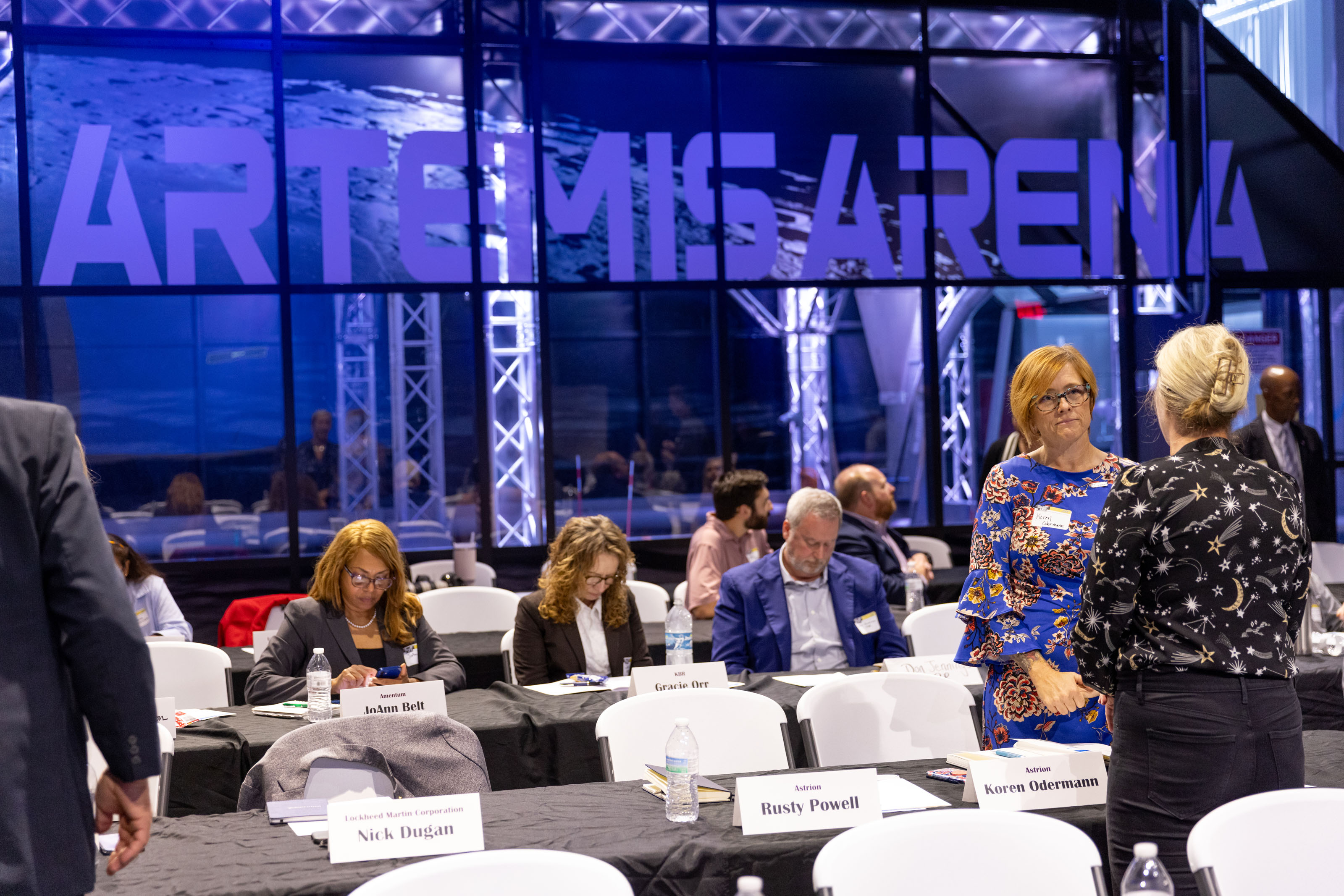 Group of people talking at the AIR conference.