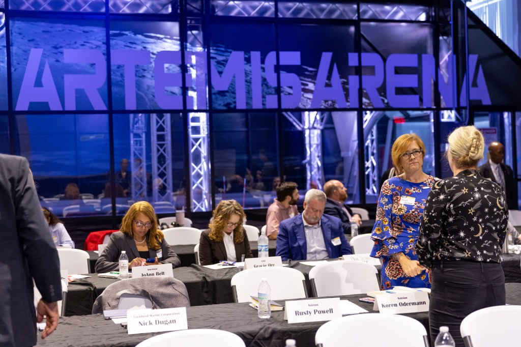 Group of people talking at the AIR conference.