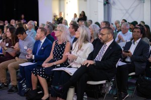 Attendees listening to opening remarks