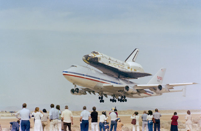 Space Shuttle Columbia on the Shuttle Carrier Aircraft, a modified 747, during the delivery flight to Kennedy Space Center to prepare for its first shuttle launch.