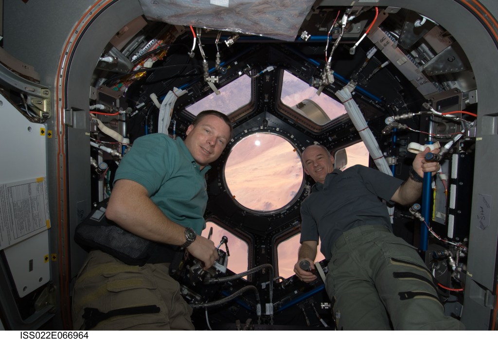 NASA astronauts Terry Virts, left, and Jeffery Williams to the right are pictured in the cupola after opening the windows for the first time.