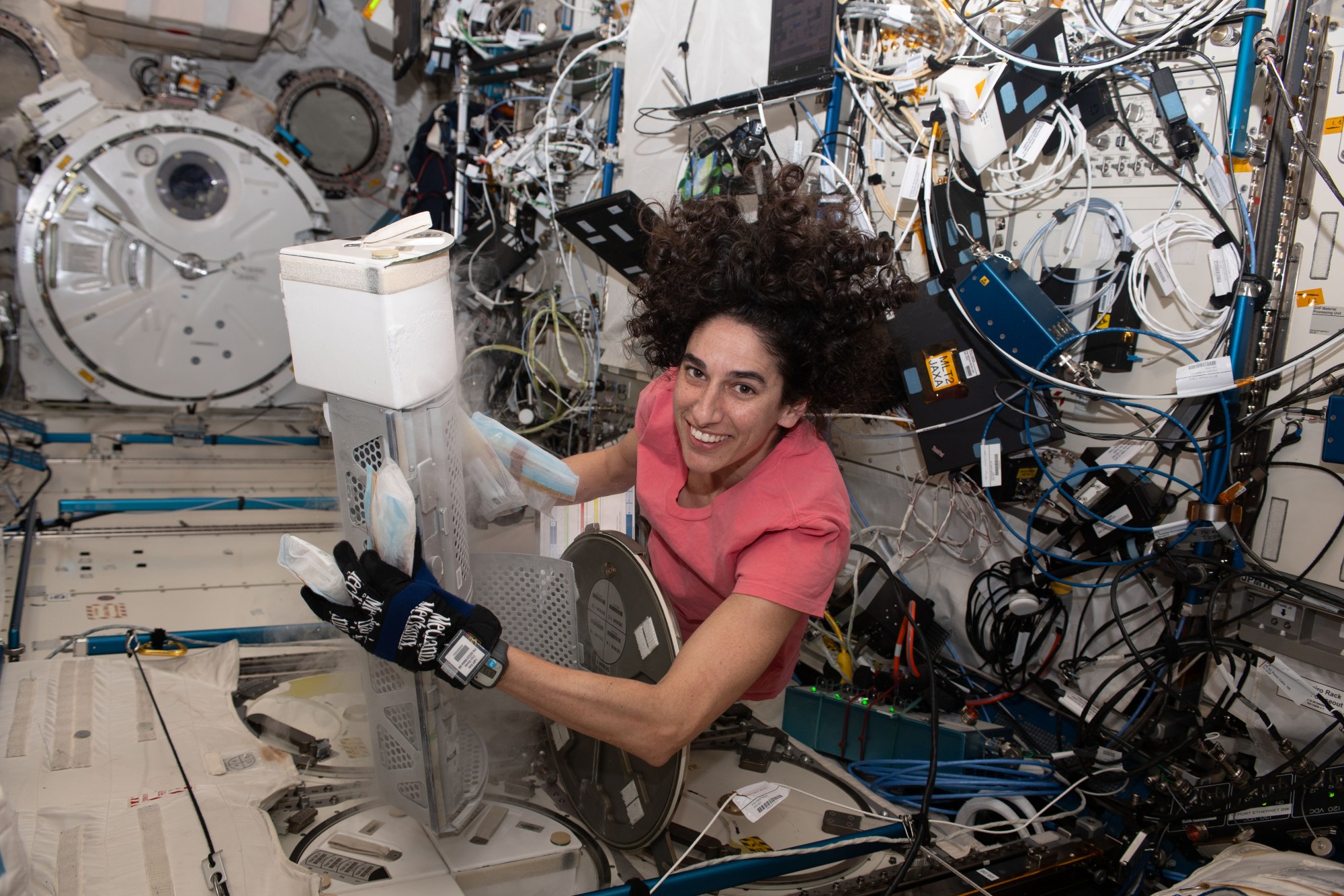 Moghbeli works with experiments aboard the space station.