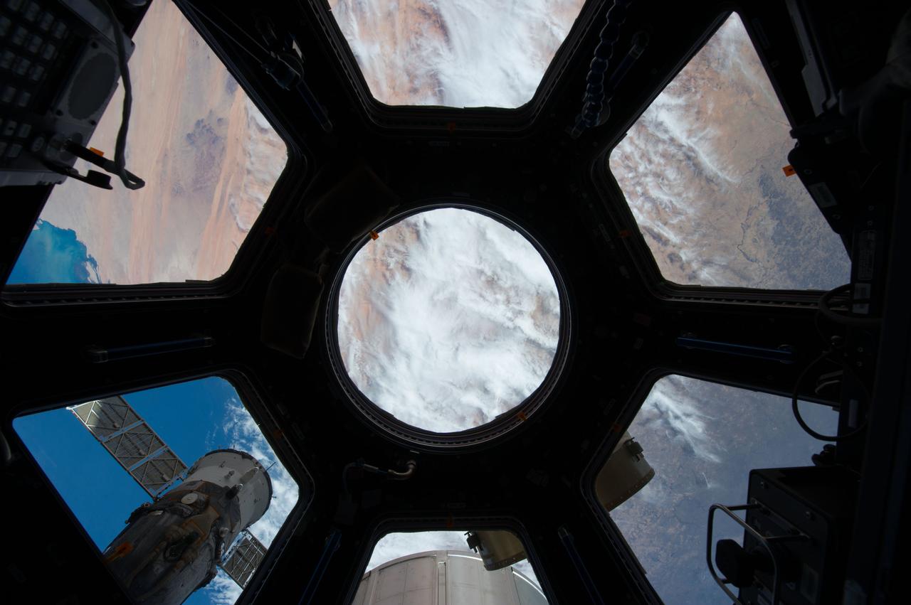 An Earth observation taken through cupola windows by the Expedition 39 crew. Portions of the International Space Station are in view.
