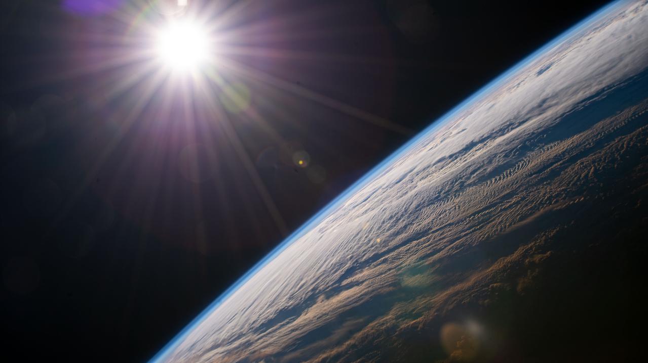 The sun shines above Earth's horizon as the space station orbits 264 miles above the Canadian province of Quebec.