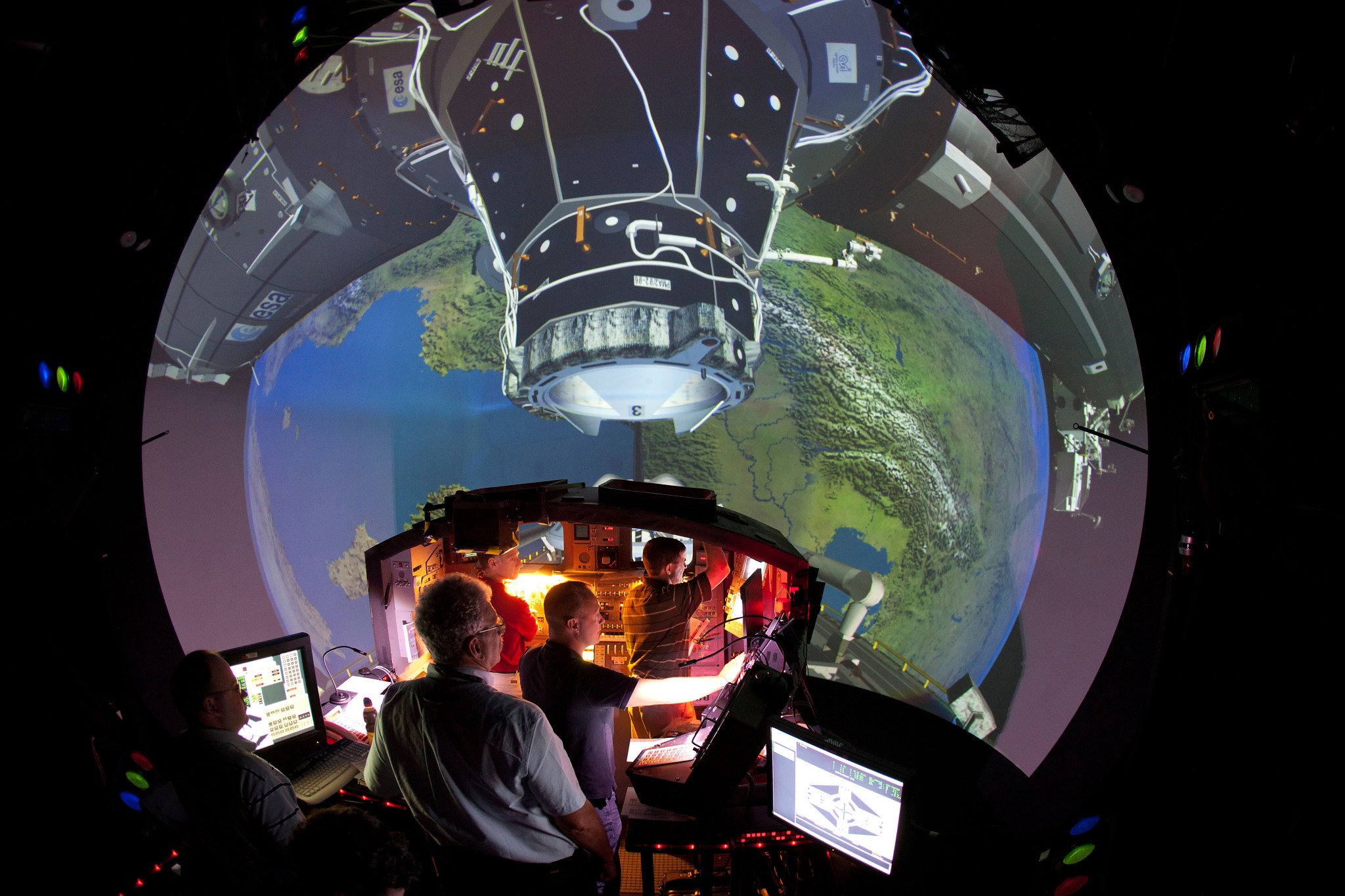 An image of people walking through an Earth dome simulation with a spacec.