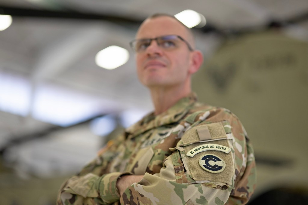 Colorado National Guard Chief Warrant Officer and military helicopter pilot Ethan Jacobs stands in the hangar bay at the High-Altitude Army National Guard Training Site near Gypsum, Colorado. NASA and the Colorado Army National Guard are partnering on a simulated lander flight training course for Artemis in the mountains of northern Colorado. Jacobs is the lead instructor and helped to develop the course.