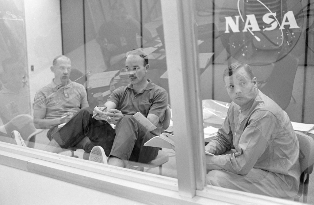 The crewmen of the Apollo 11 lunar landing mission go through their post flight debriefing session on Sunday, July 27, 1969