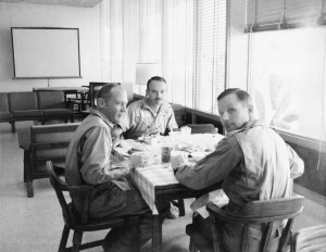 The crewmen of the historic Apollo 11 lunar landing mission are seen dining in the Crew Reception Area of the Lunar Receiving Laboratory