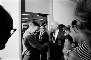 Apollo 11 Crew leaving the Lunar Receiving Laboratory (LRL) at the end of their Quarantine period. 1. Bldg. 37 - Apollo 11 MSC, Houston, TX. Neil Armstrong shaking hands with Robert R. Gilruth in center.