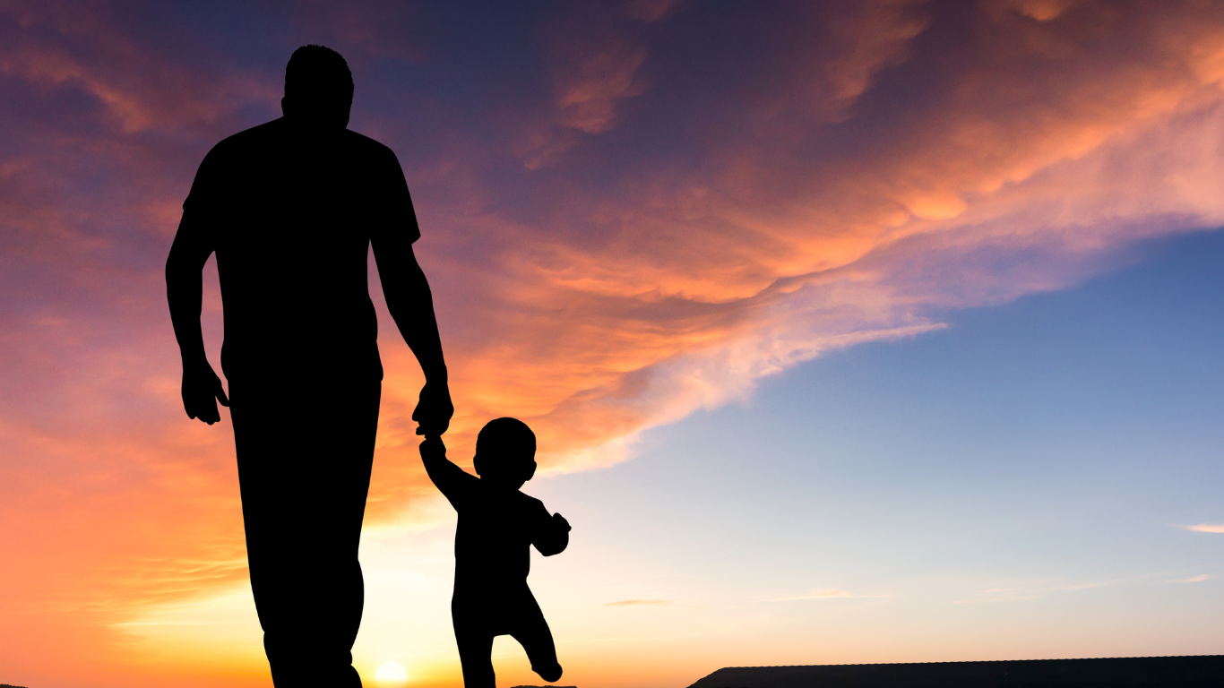 A parent and child holding hands.