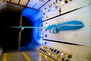 Half of a large model of a possible future commercial jet airplane split lengthwise is seen inside a NASA wind tunnel.