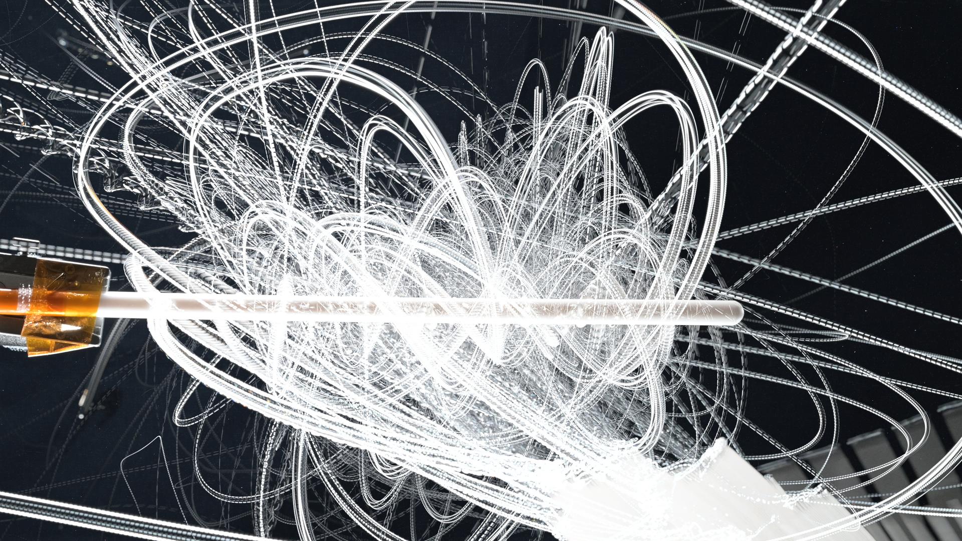 White streaks of motion swirl and swoop all over the image. At the middle of the image is a Teflon knitting needle.