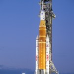 NASA's orange and white Space Launch System rocket on the launch pad.