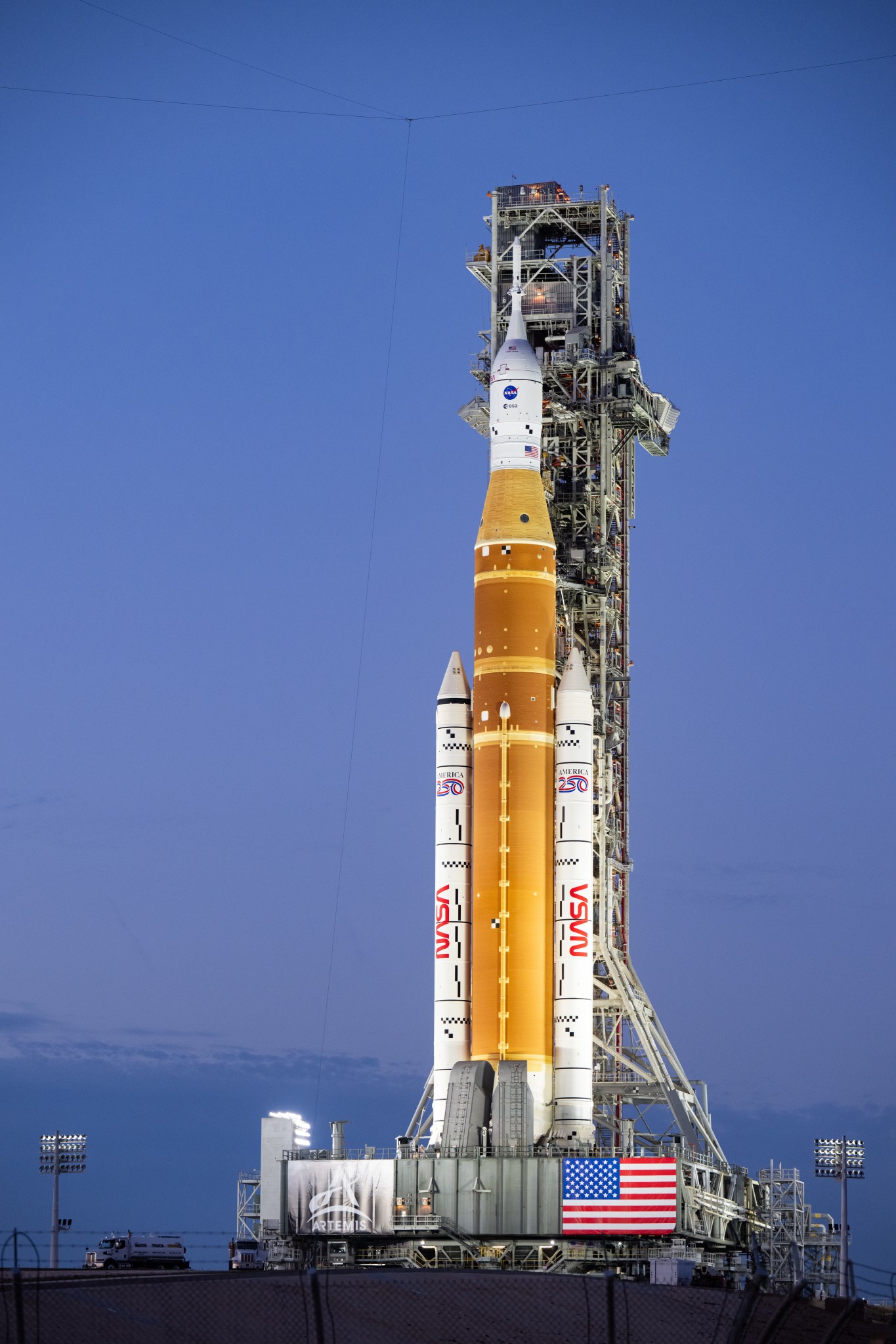 NASA's orange and white Space Launch System rocket on the launch pad.