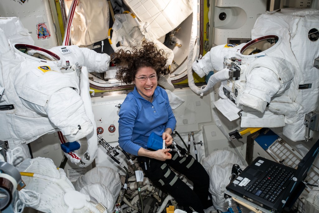 Expedition 60 Flight Engineer Christina Koch of NASA works inside the Quest joint airlock cleaning U.S. spacesuit cooling loops and replacing spacesuit components.
