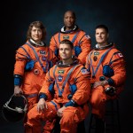 NASA astronauts Reid Wiseman, Victor Glover, and Christina Hammock Koch, and CSA astronaut Jeremy Hansen pose in their orange flight suits for a photo.