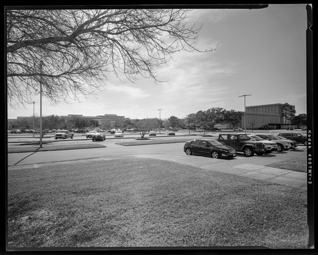HAER-TX-109-N-12, South view from Building 31 front entrance and Cactus Garden towards JSC including Northeast corner of building 10 and North facing view of Building 7 high bay