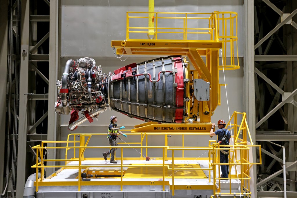 Technicians move an RS-25 engine at Michoud Assembly Facility