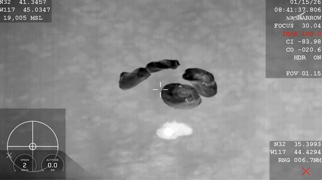 Spacecraft splashes down in ocean.